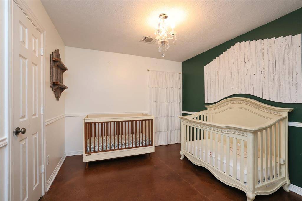 This secondary bedroom offers chair rail, ceiling fan, and great closet space.