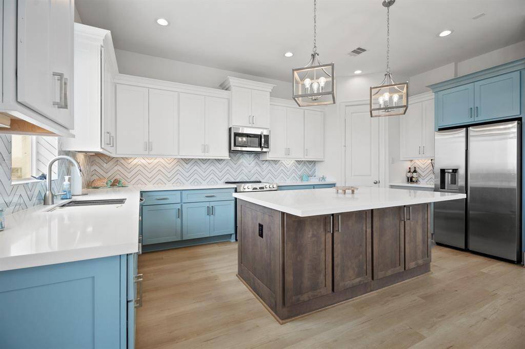 Entertainer's dream kitchen with large island, custom cabinets and backspash