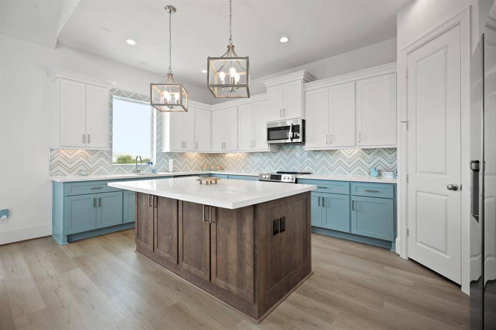 Entertainer's dream kitchen with large island, custom cabinets and backspash