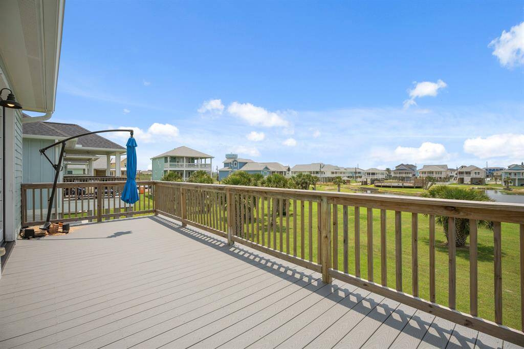 Back deck with view of the pond and private community pool and pool house