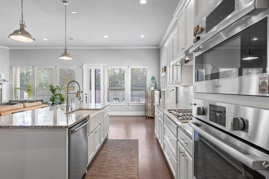 Oversized kitchen looking into breakfast room with an abundance of windows