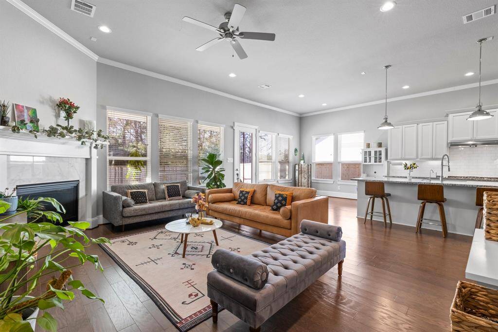 Family room is adjacent to the kitchen and breakfast room and has a remote controlled gas log fireplace with windows that take in the view of the fabulous backyard