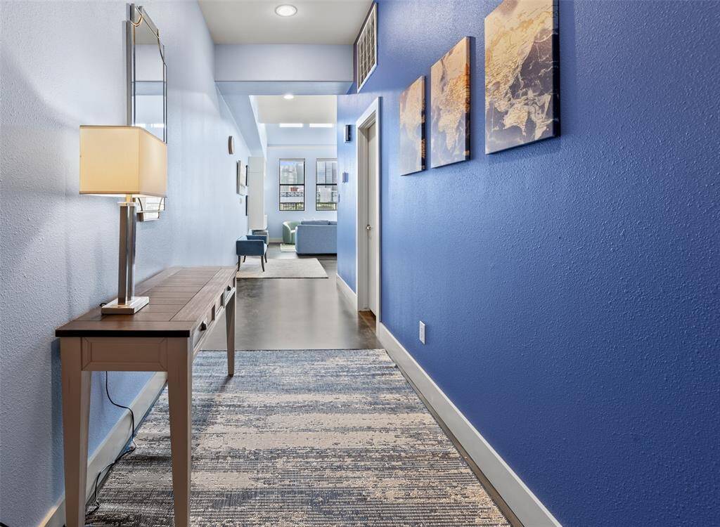 Long entry hall with gallery walls welcome you