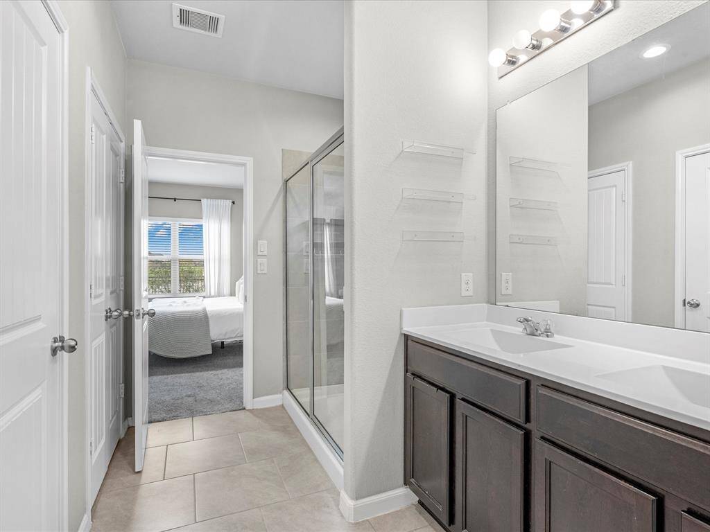 Primary bathroom features a stand up shower, dual sinks, walk in closet, private toilet, and so much more.