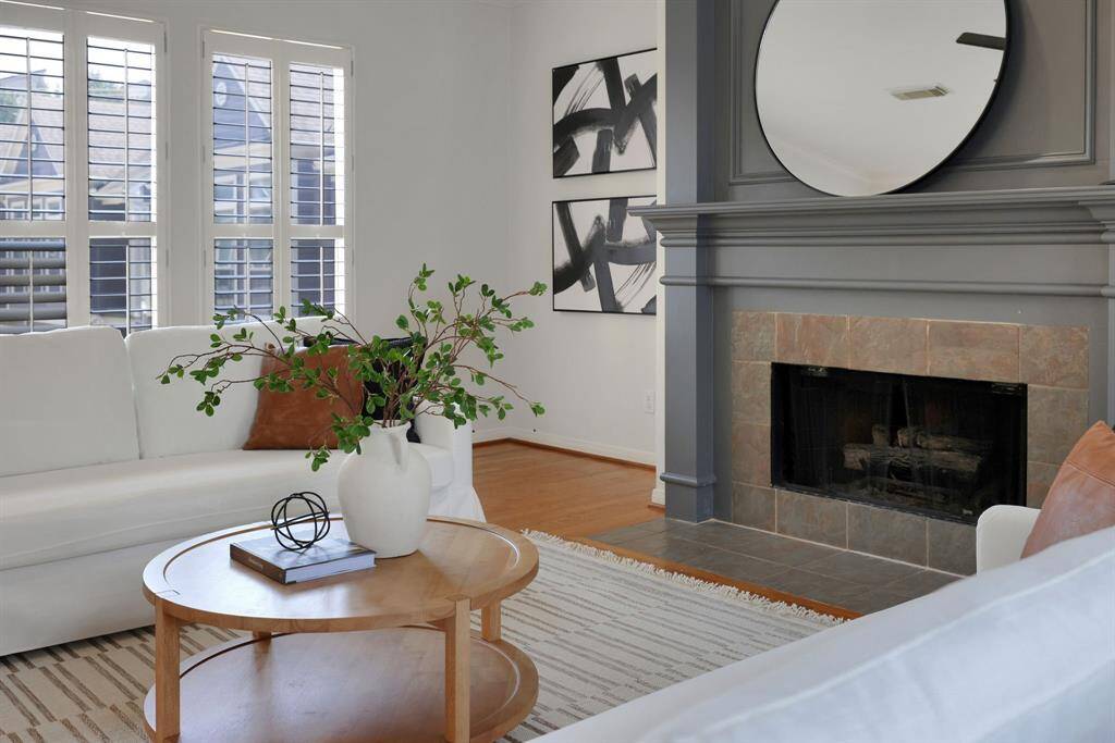 The perfect angle showcasing the fireplace as the room’s centerpiece, surrounded by a flood of light from oversized windows