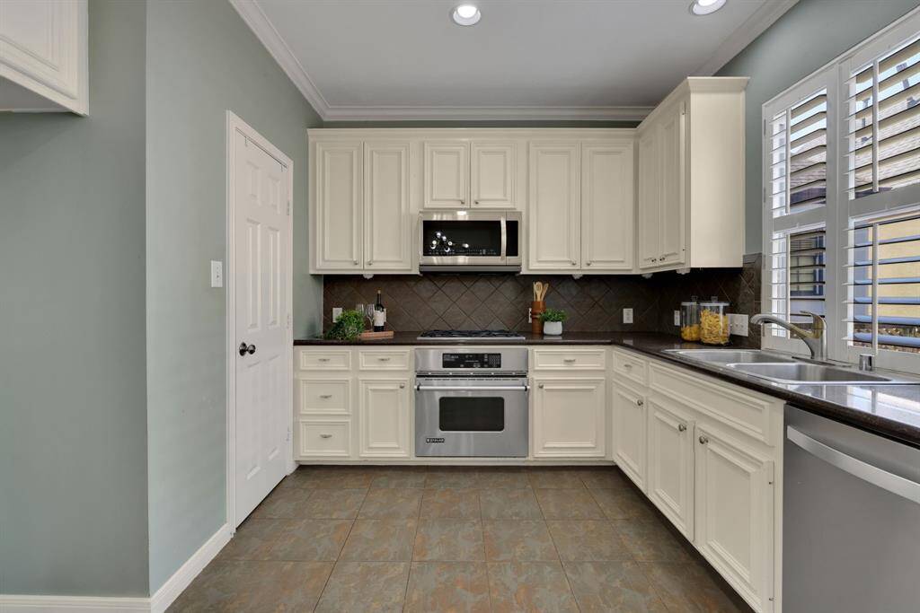 Sleek cabinetry, stainless appliances make this kitchen a true culinary hub