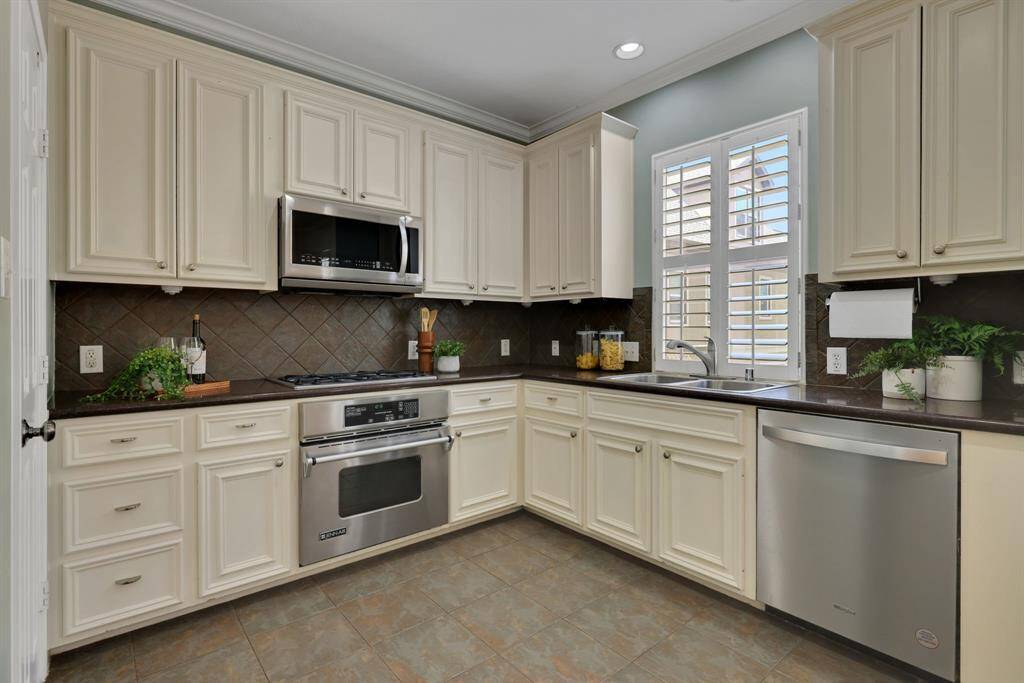 The kitchen reveals generous counter space and open sightlines