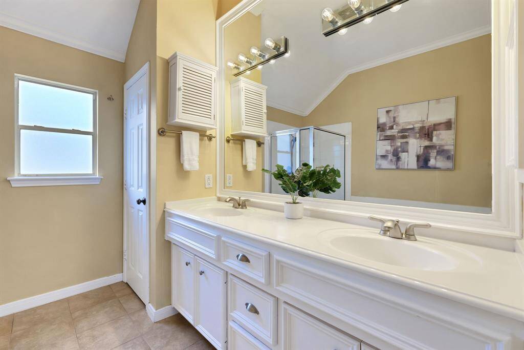 A focused look at the dual vanities, offering ample storage and modern finishes for a streamlined start to your day