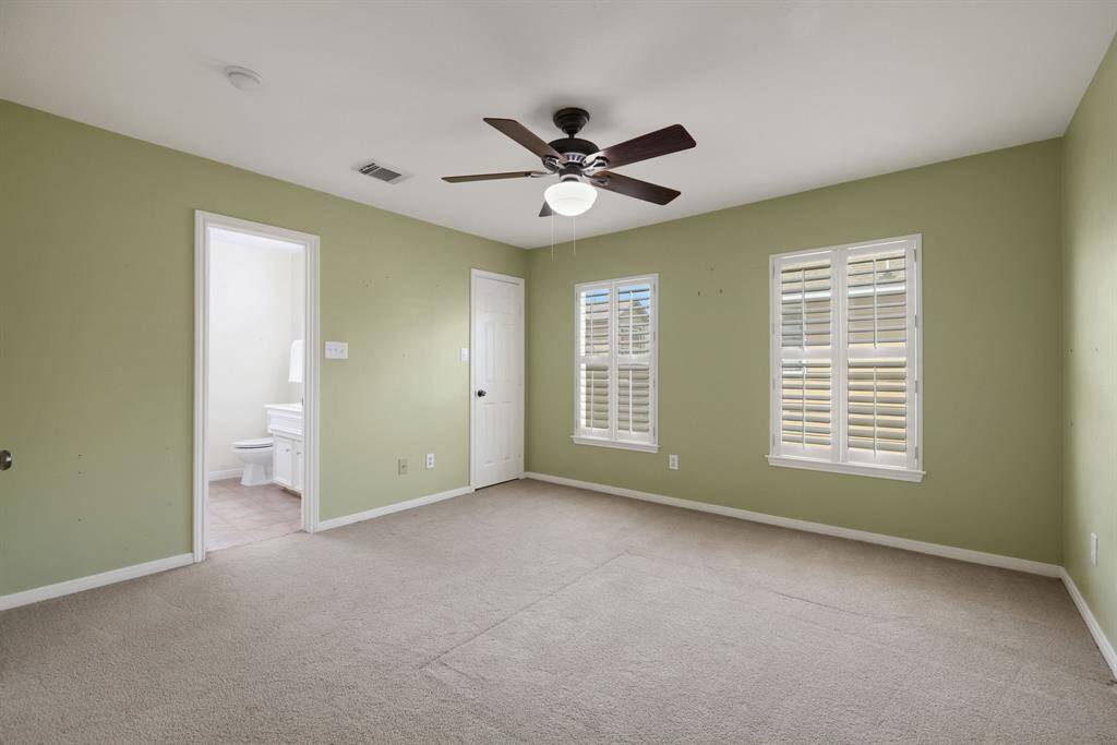 The secondary bedroom highlights the generous windows that fill the room with sunshine