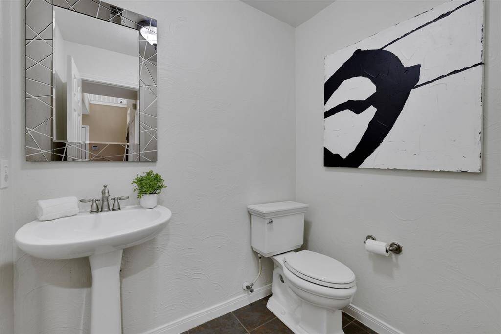 A stylishly appointed half bath with modern finishes conveniently located on the main floor for guests