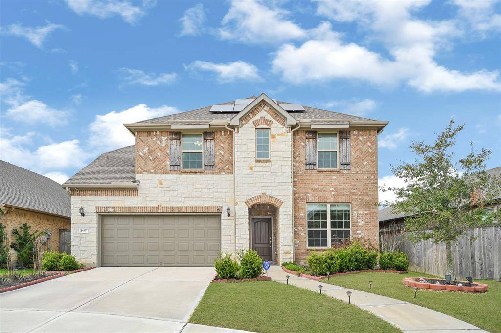 Majestic Elevation – Stunning northeast-facing, brick and stone two-story home in a peaceful cul-de-sac