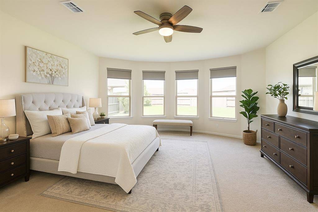 Lavish Primary Suite – Bay windows offering scenic backyard views
