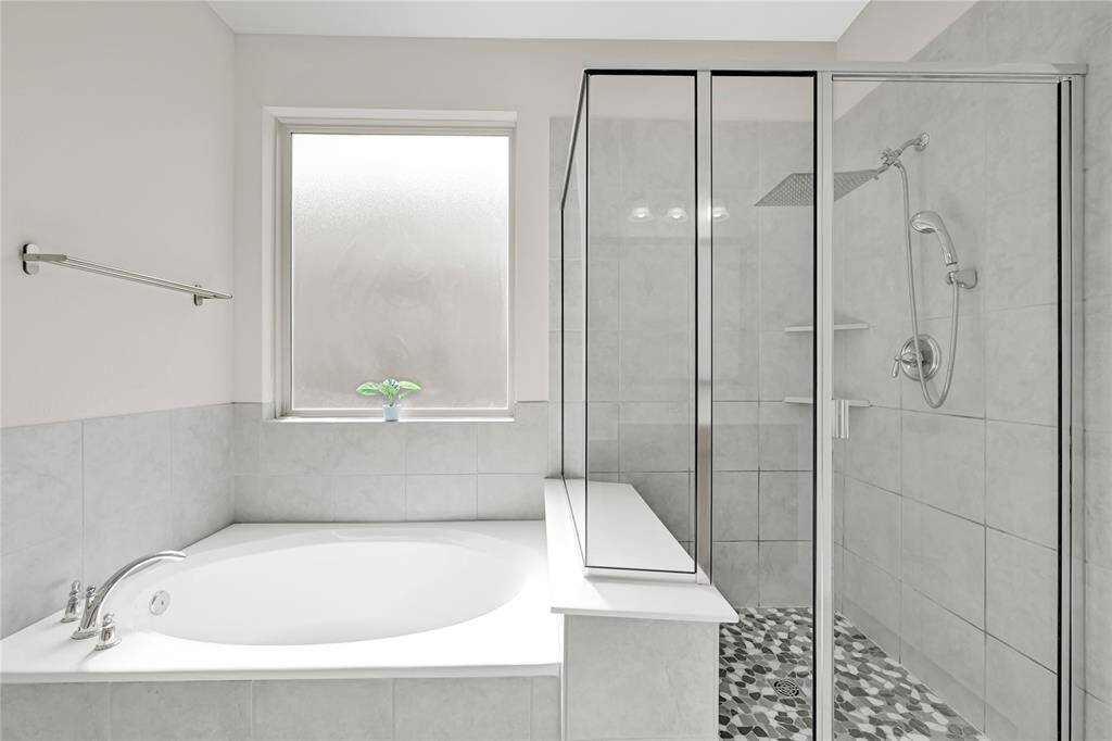 Spa-Like Primary Bath – Dual sinks, a luxurious rainfall shower, and a spacious soaking tub