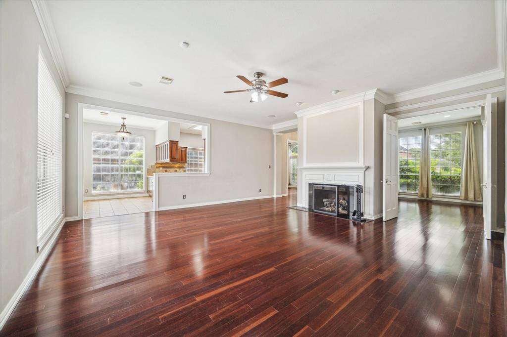 A white-trimmed gas fireplace with a detailed mantle anchors the living space.