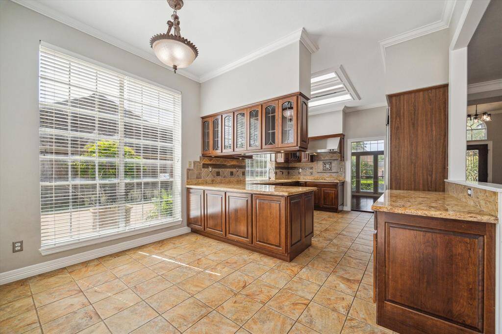 The cheerful breakfast area is bathed in natural light from a wall of windows, offering the perfect spot to start your day.