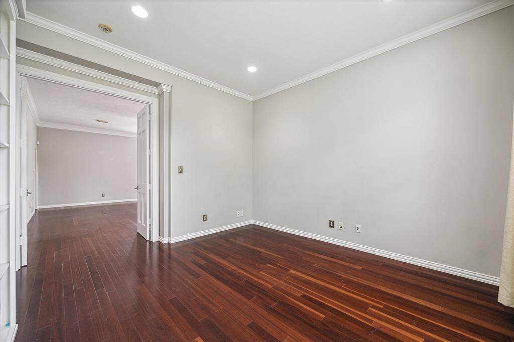 Double French doors connect the private home office to the main living space, creating a functional retreat perfect for working from home.