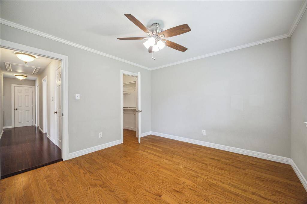 A generous walk-in closet and convenient hallway access make this secondary bedroom a functional and comfortable space.