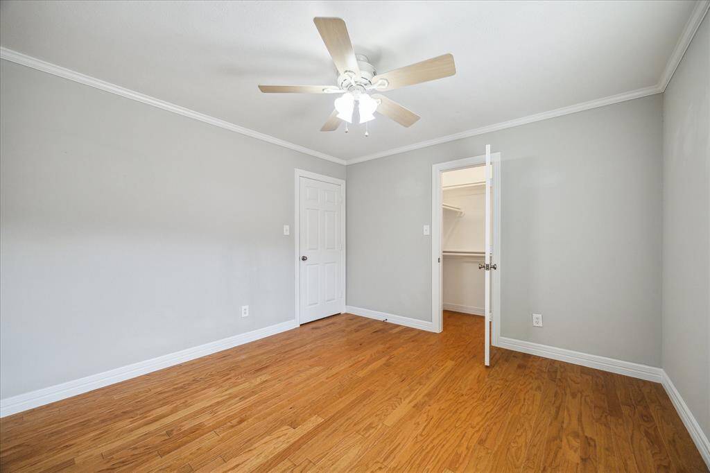 This fourth bedroom includes a spacious walk-in closet and easy access to the hallway bath—perfect for guests or family members.