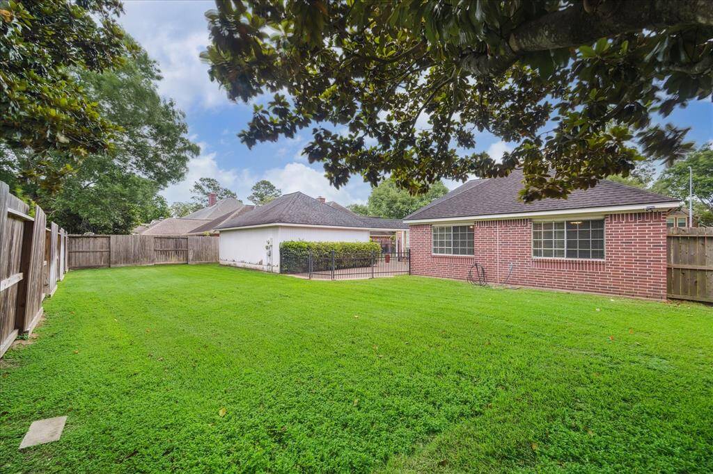 A large grassy yard offers endless possibilities for outdoor fun, gardening, or future plans.