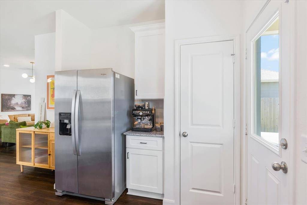 Kitchen features granite countertops , beautiful white cabinets with updates hardware, stainless appliances, large sink and natural light.