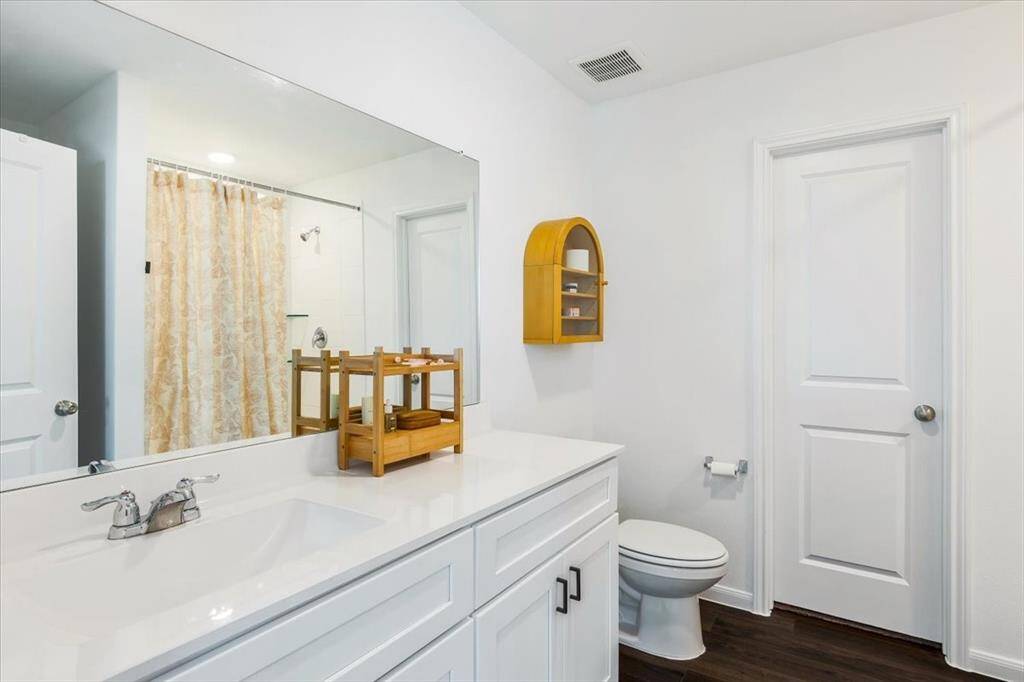 Primary bathroom features ample counter space and walk in shower.