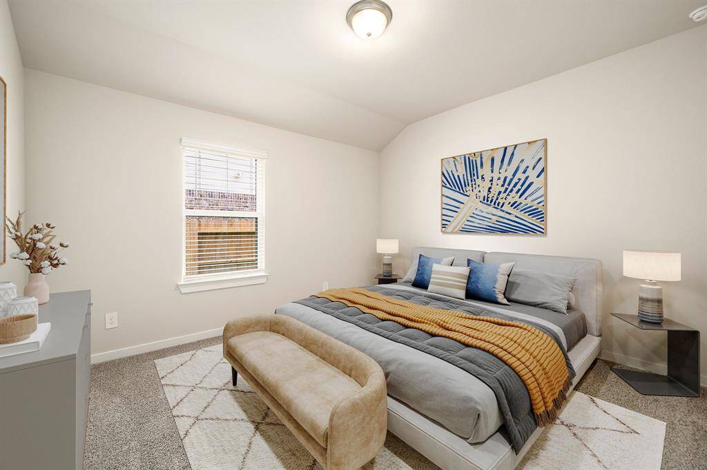 This inviting bedroom is filled with natural light from wide windows and showcases a soothing color scheme. The high ceiling creates an open, airy feel, while the soft carpeting adds a touch of comfort underfoot.