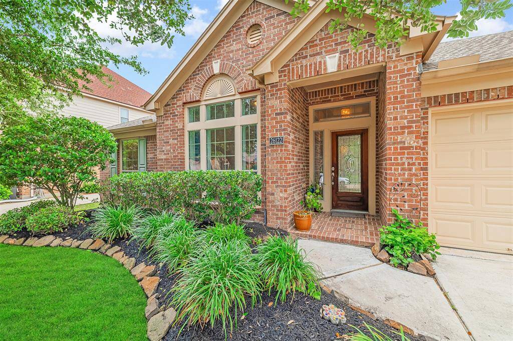 Covered front porch and a leaded glass front door.