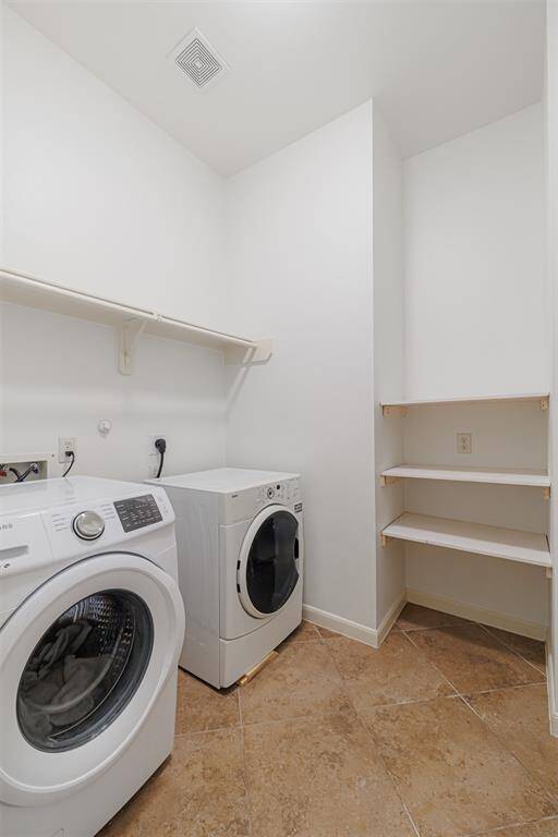 The laundry room features built-in shelving.