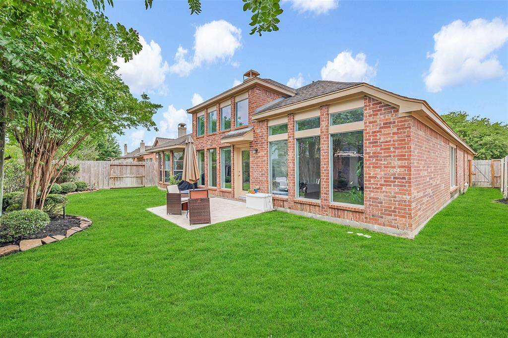 Step outside to a beautifully landscaped backyard with a patio and sprinkler system—perfect for relaxing or entertaining!