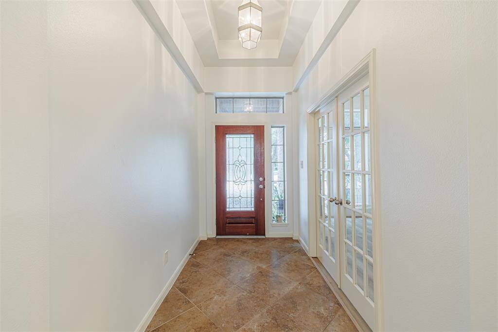Tiled entry with tray ceilings.