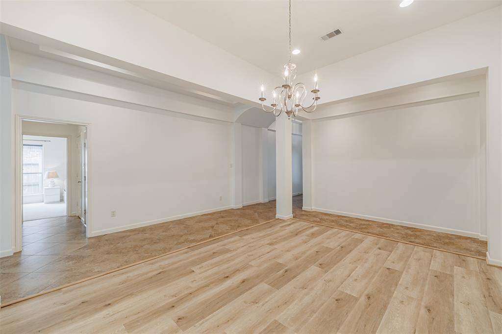 Formal dining features a chandelier, recessed lighting and luxury vinyl flooring.