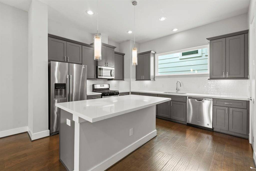 Second floor- kitchen with stainless appliances, quartz counters, and refrigerator included!