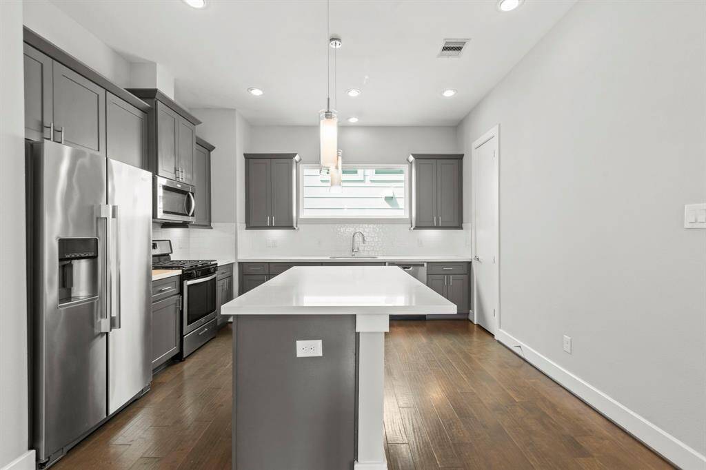Second floor- kitchen with stainless appliances, quartz counters, and refrigerator included!