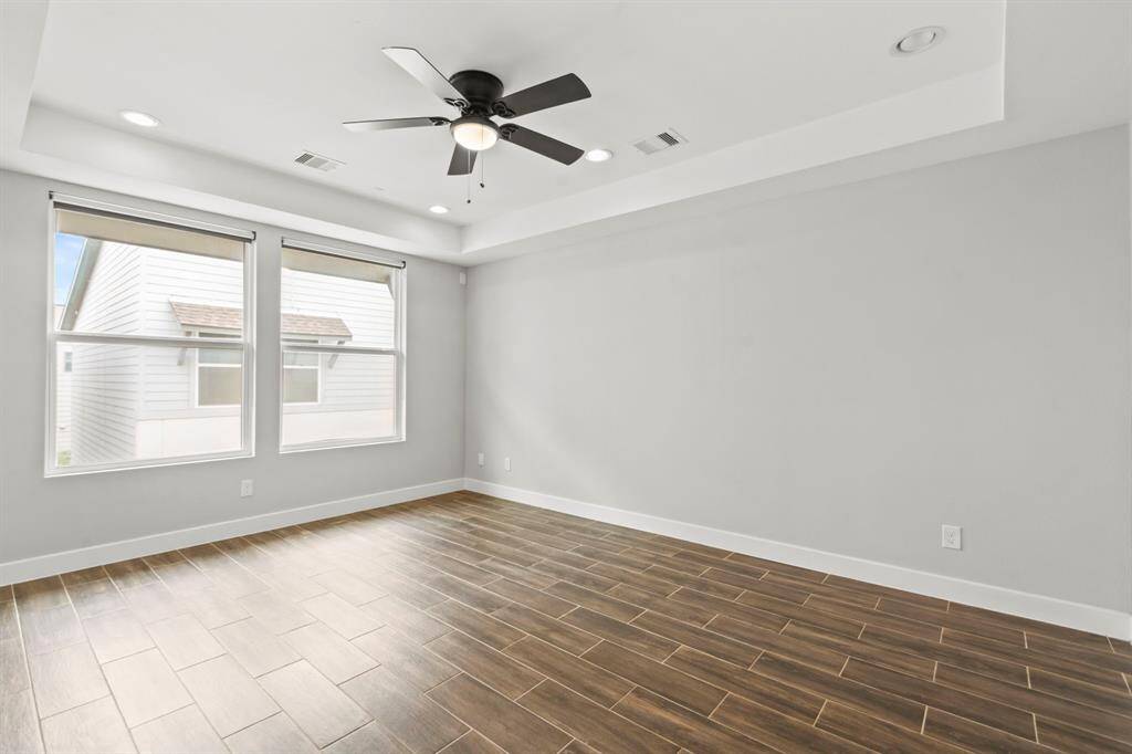 Third floor- Large primary bedroom with vaulted ceiling. Tile throughout 3rd floor.