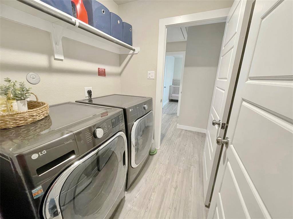A nice sized laundry room with plenty of storage is located inside the house.