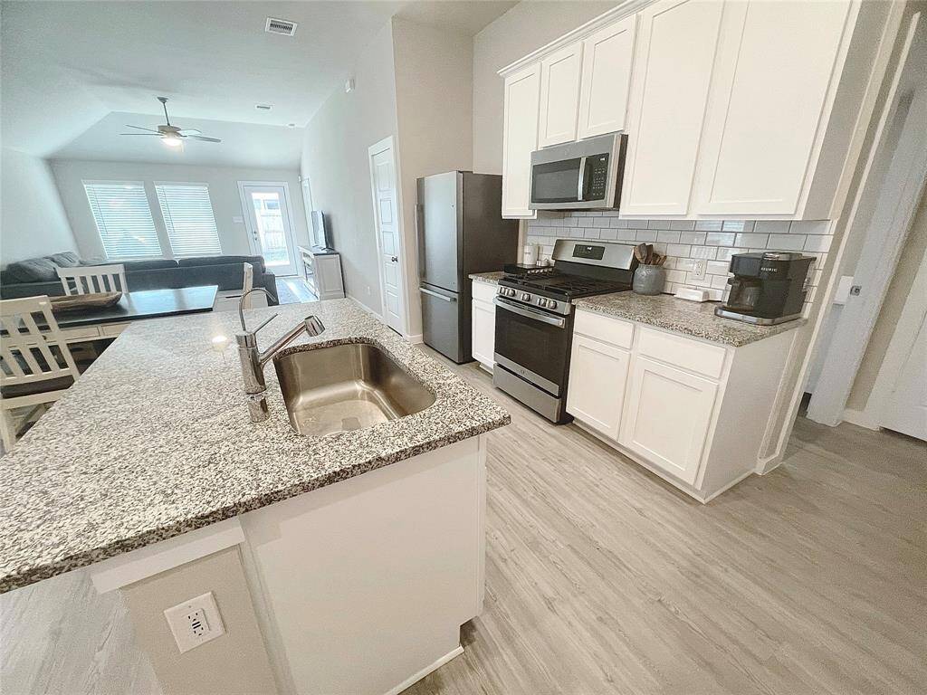 Beautiful granite countertops, white cabinets, gas stove, and stainless steel appliances!