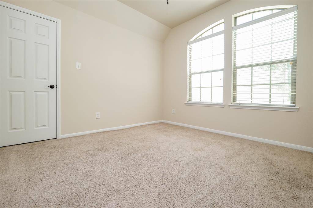 Double arched windows bring morning sunshine and deep night skies into this generous secondary bedroom; any of which may serve as a nursery, hobby room, work out space? It's all up to you.