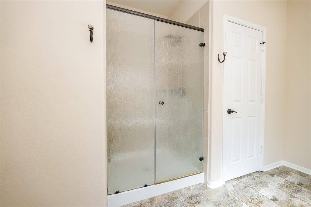 Your primary walk-in shower makes for a comfortable, practical use of space!