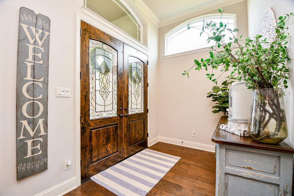 Step through the elegant front door into a grand entryway that sets the tone for the entire home.