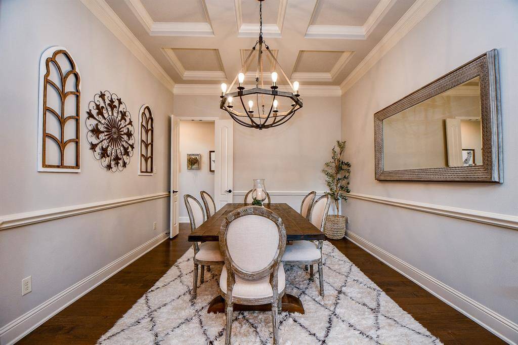 Featuring elegant architectural details such as crown molding, tray ceilings, and designer lighting, the room exudes timeless charm.