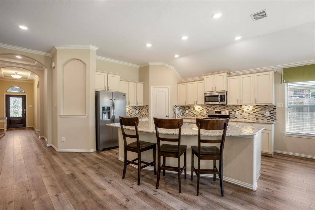 Under cabinet lighting and stainless-steel appliances complete the Kitchen