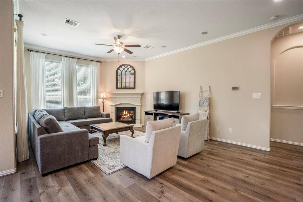 This Family Room, on the back of the house, features an abundance of natural light and a corner fireplace