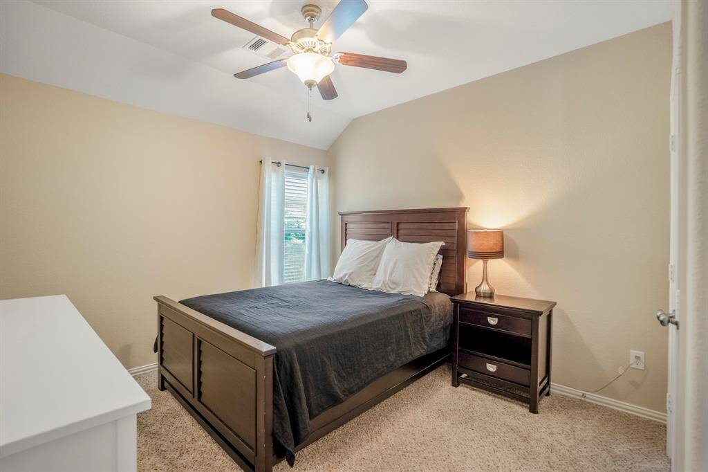 Carpeted Secondary Bedroom with crown molding and a ceiling fan