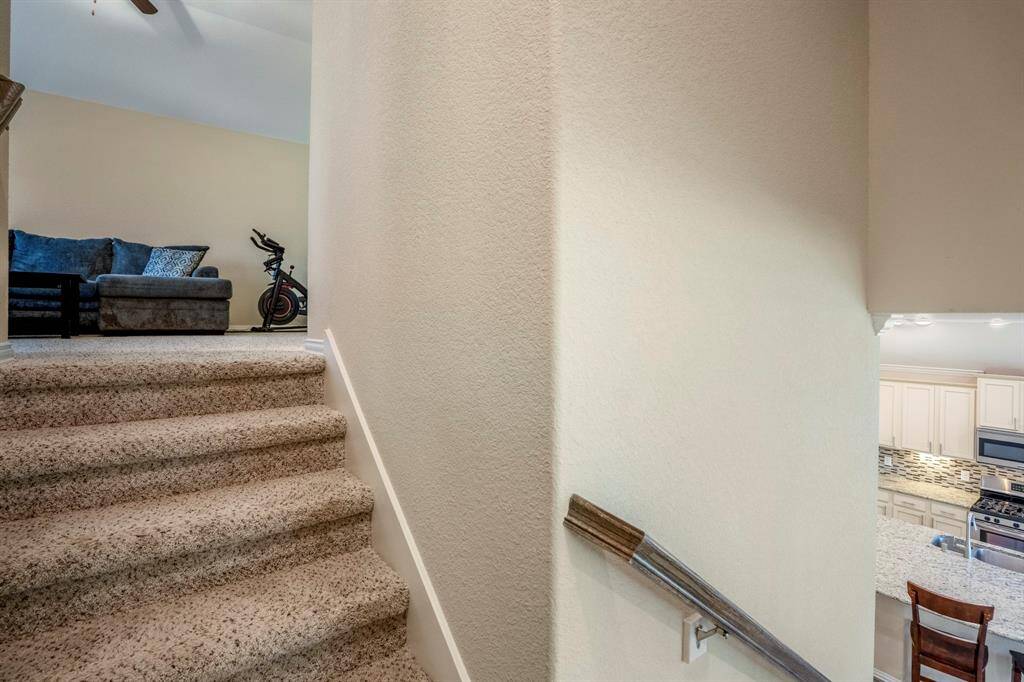 Carpeted stairs lead to upstairs Gameroom