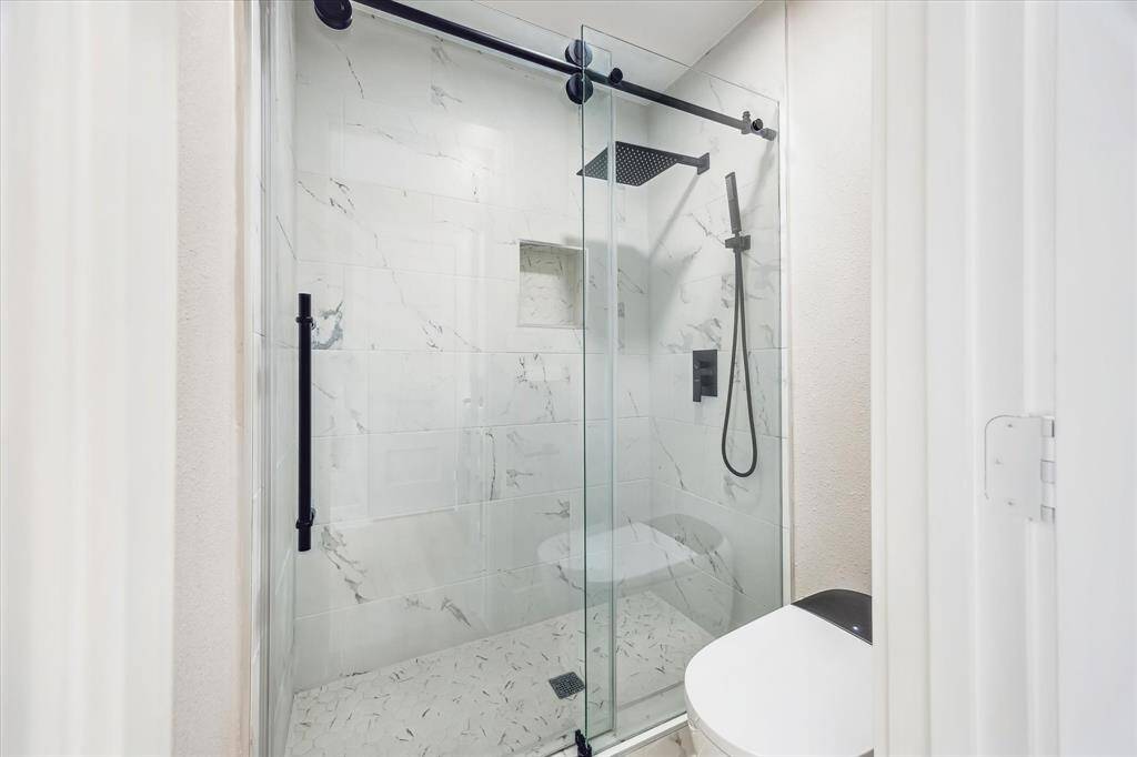 View of the primary shower and toilet.  Automated bidet toilet!  No detail or expense was spared in the remodel!