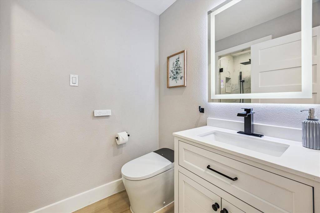 Secondary bathroom across the hall from the bedroom.  Note the automated smart toilet and lighted mirror.