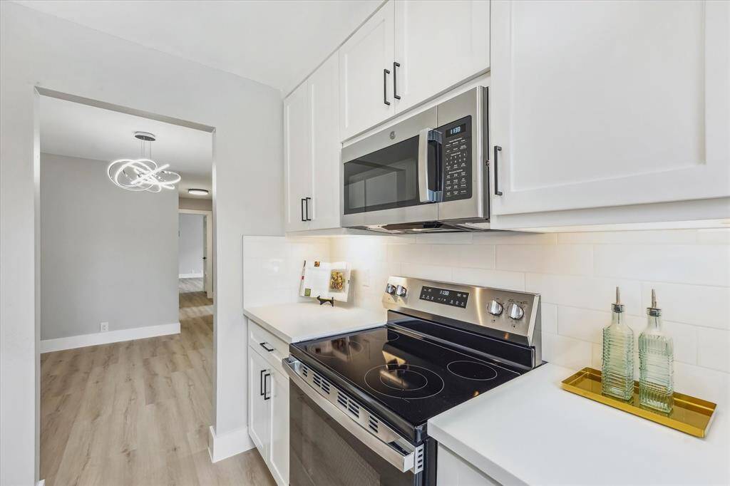 Beautiful remodel which offers custom on-site built solid wood cabinetry, quartz countertops, subway tile, SS appliances, soft close cabinets & drawers and under cabinet lighting.