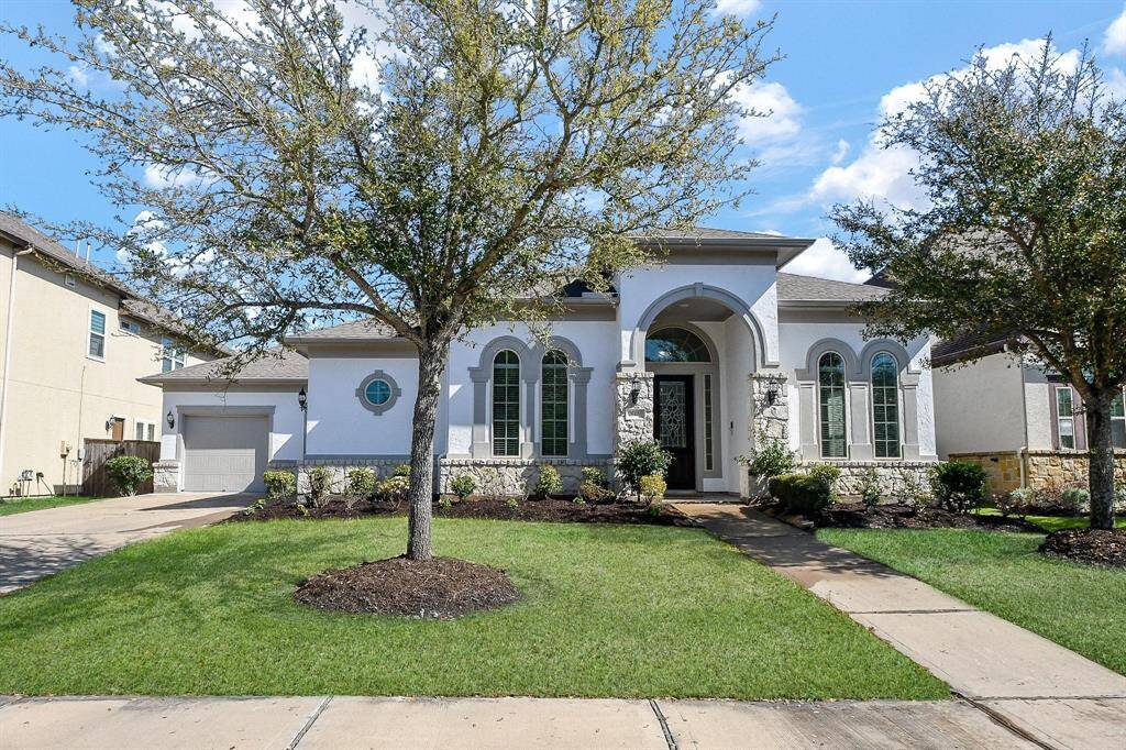 This elegant home features a stunning facade with arched windows and a grand entrance. The well-maintained lawn and tasteful landscaping enhance its curb appeal. Ideal for buyers seeking a welcoming and stylish property.
