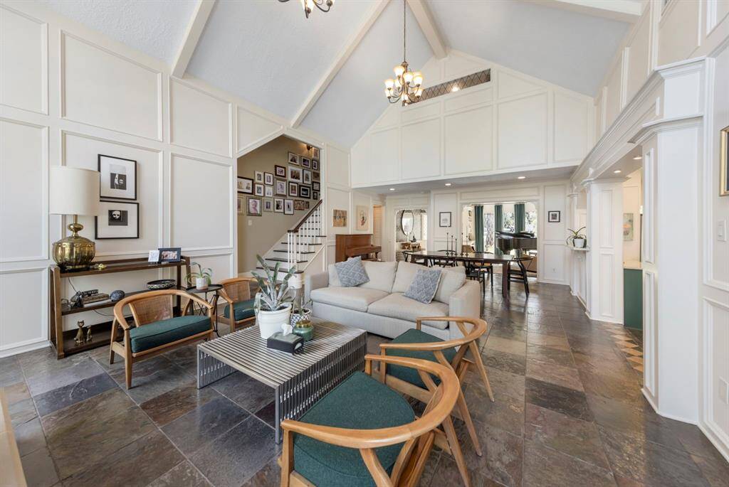 Soaring vaulted ceilings paired with fresh neutral paint create an open, airy atmosphere throughout the home.