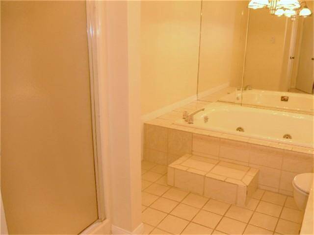 Master bath with separate shower and double jacuzzi tub